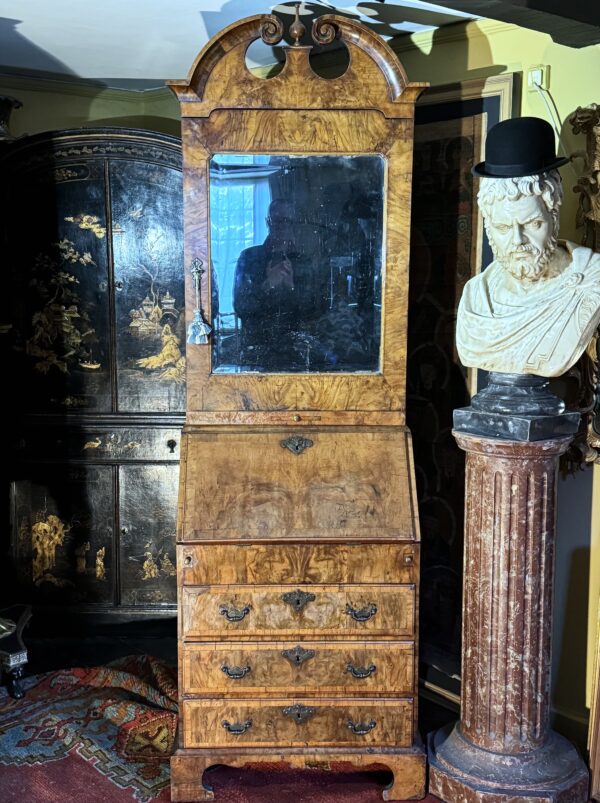 A rare small early-18th century walnut bureau bookcase/ cabinet in situ