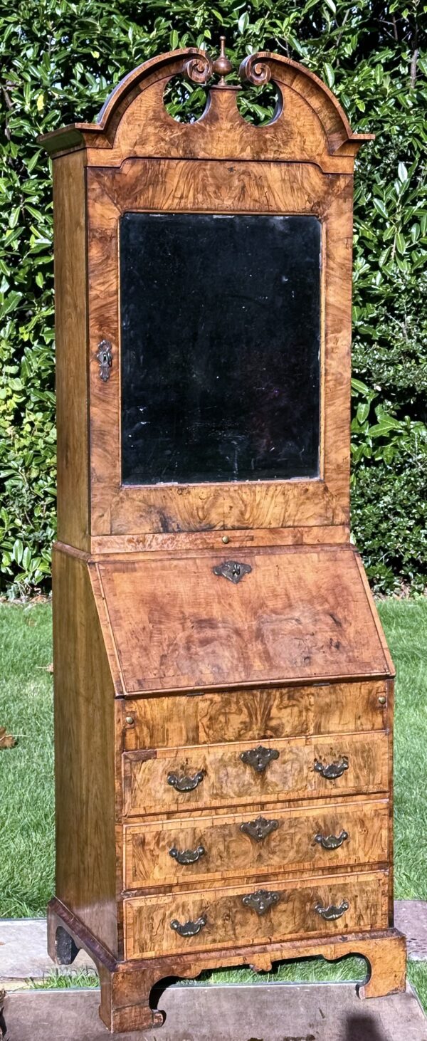 A rare small early-18th century walnut bureau bookcase/ cabinet outside